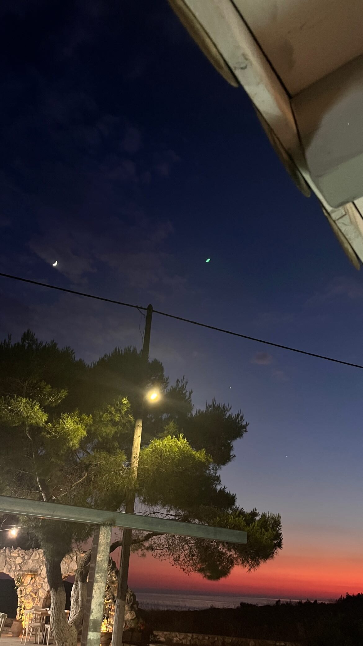 Moonlit sky over the taverna at dusk