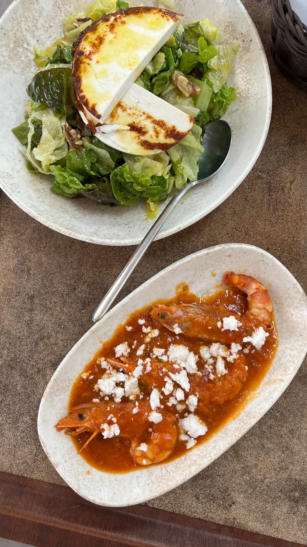 A green salad and shrimp saganaki with feta